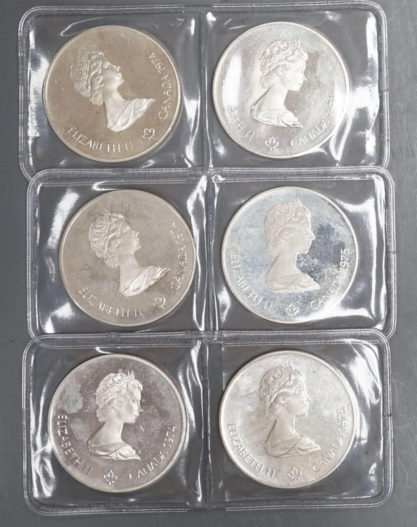 Six Canadian $5 silver Olympic Coins Montreal 1976 Games, total weight 146.4 grams.